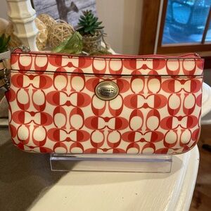 Coach Op Art Signature Wristlet in a pink and white coated Canvas